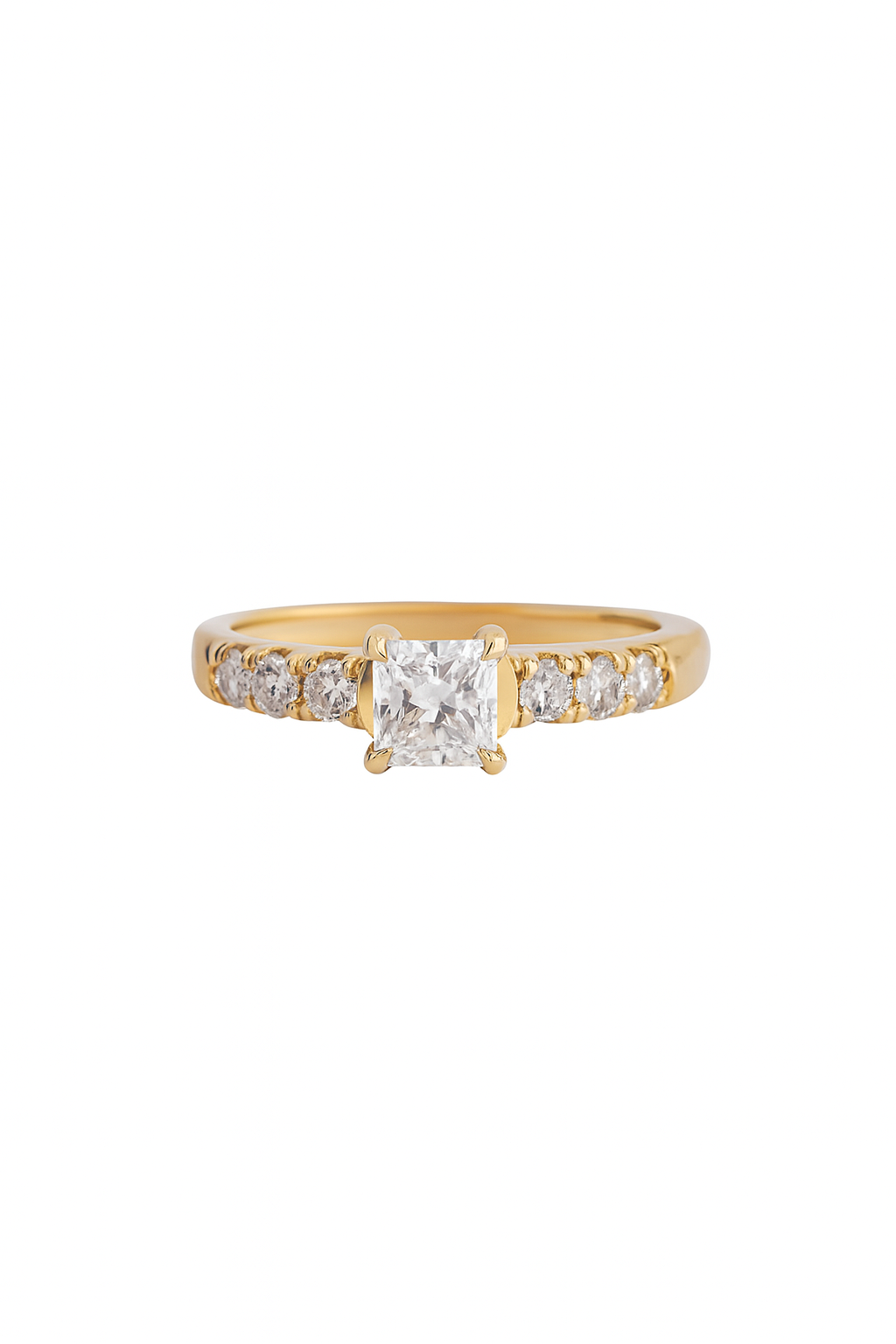 Gold ring with a large diamond and smaller diamonds on the band against a white background