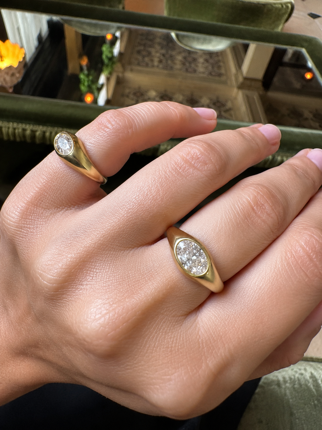 Oval diamond Relic ring worn on hand with marquise diamond ring, satin 14K gold